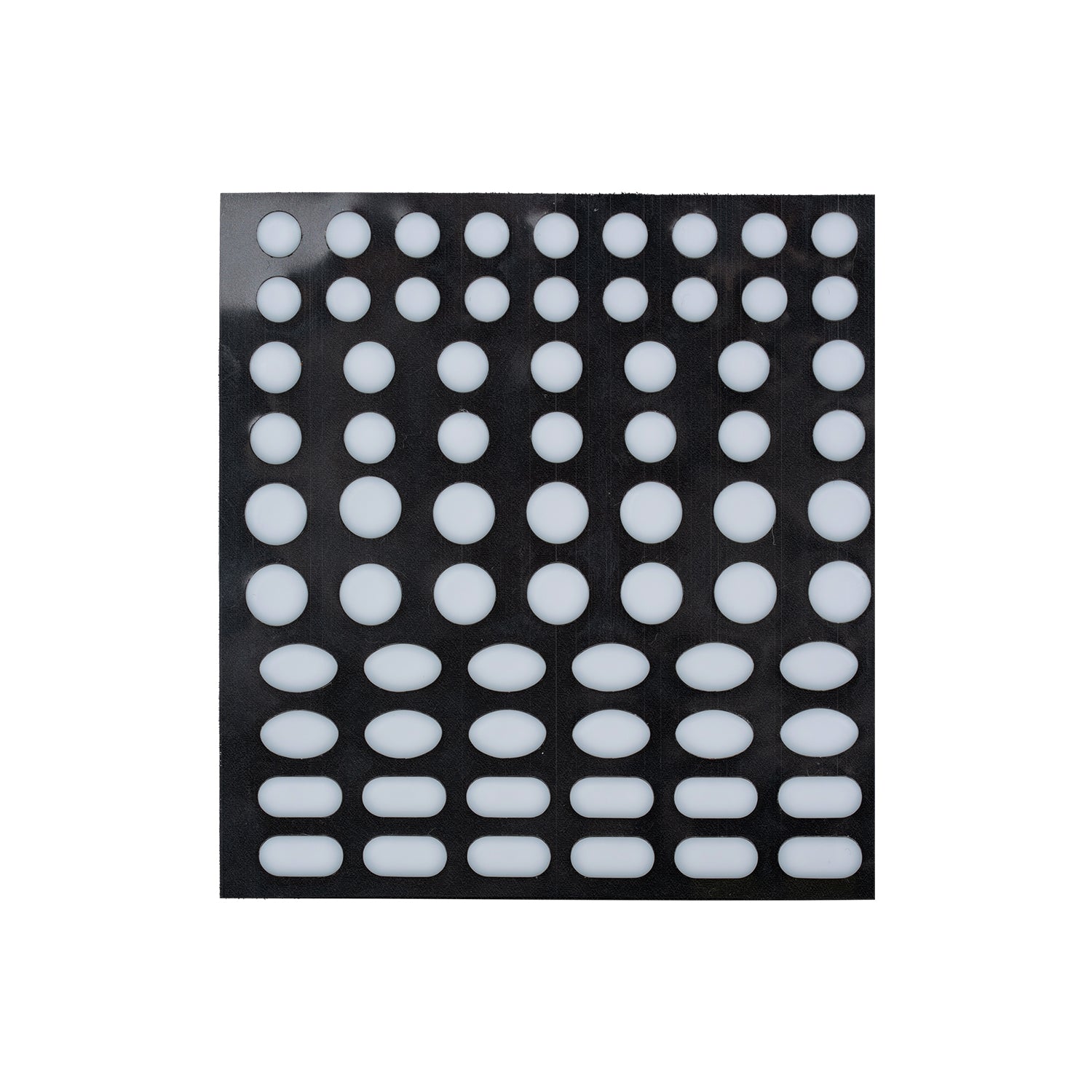 Sheet of round and oval white adhesive pads on a black backing.