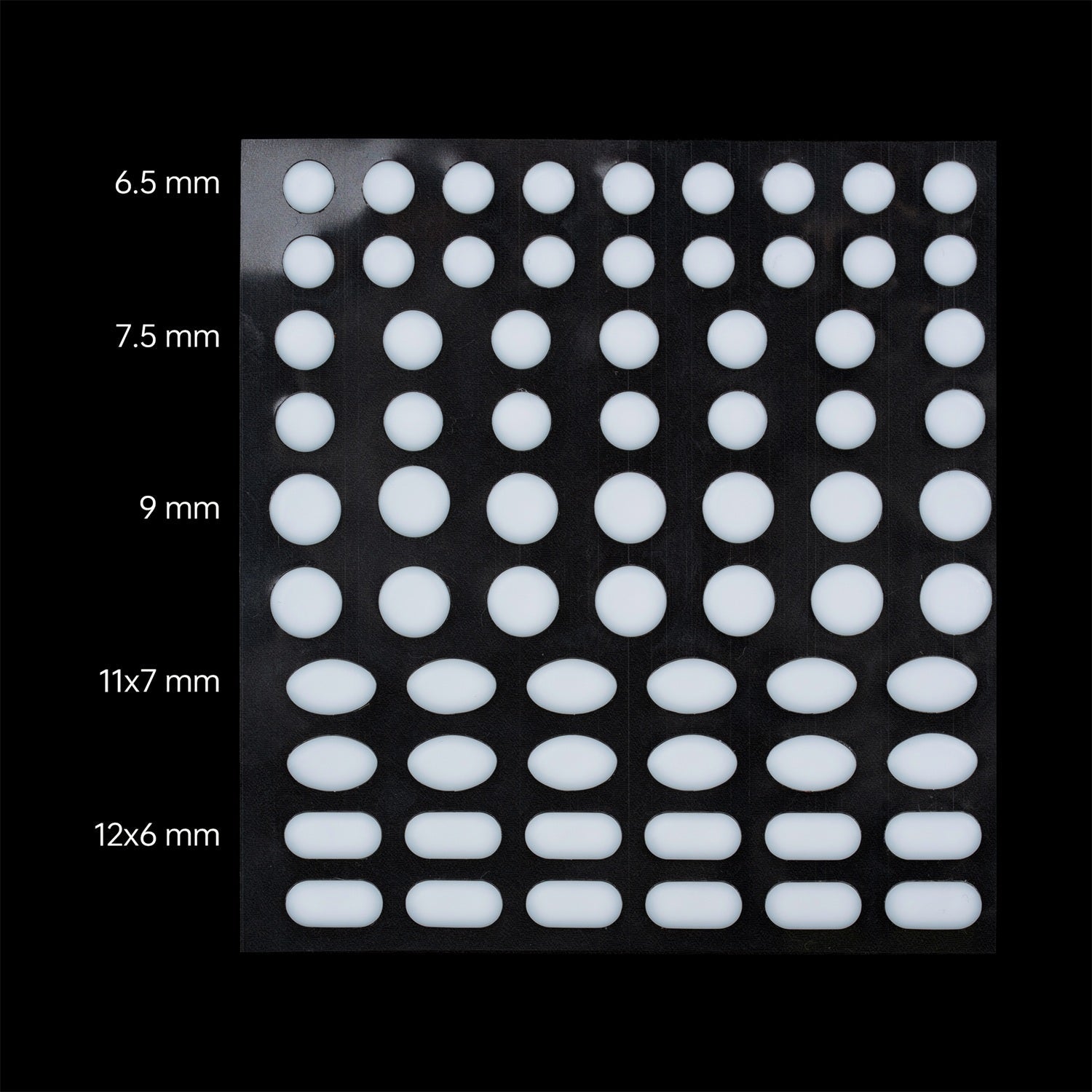 Sheet of white circular and oval adhesive pads in various sizes: 6.5mm, 7.5mm, 9mm circles, and 11x7mm, 12x6mm ovals.